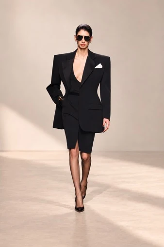 Black skirt suit with a long structured jacket and satin lapels